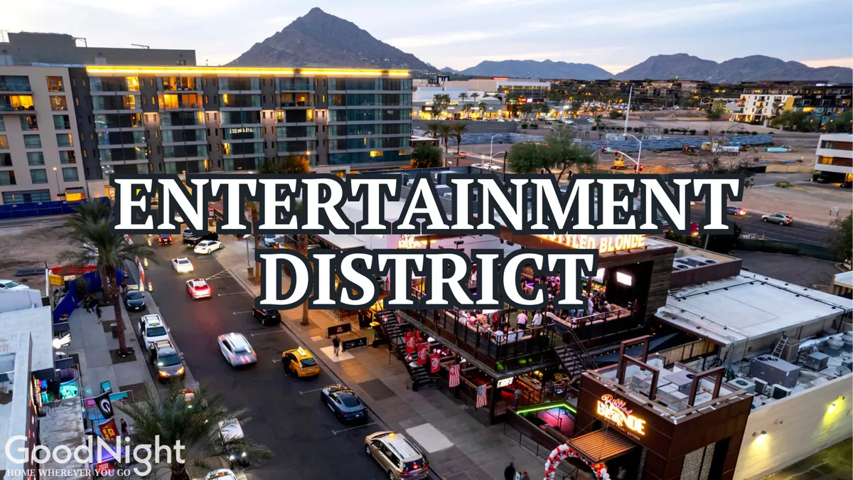 A vibrant entertainment district scene, featuring neon signage, a busy street with cars, lively outdoor dining areas, and the mountain backdrop. People are seen engaging in nightlife activities, dining, and socializing.